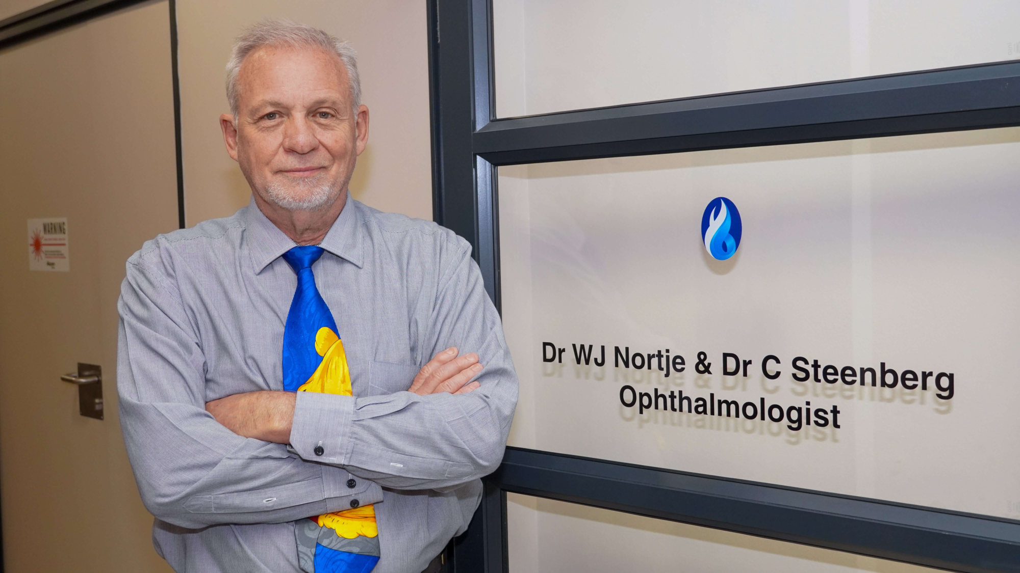 Dr Bill Nortje standing in front of his office.